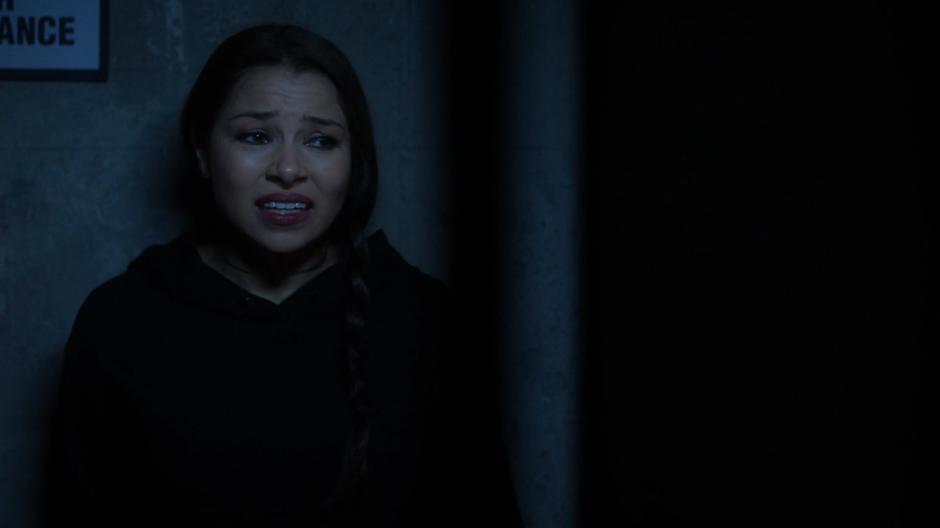 Nora leans against the wall of the alley and tells Thawne that she cannot bring herself to try phasing.