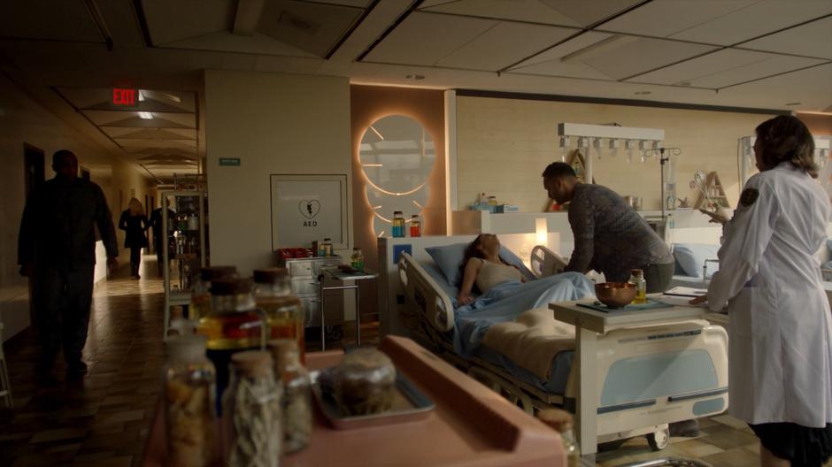 Dean Fogg walks back into the room to where Penny is leaning over Julia's hospital bed.