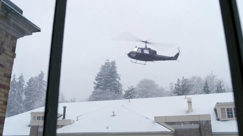 A helicopter hovers in the air outside the prison.