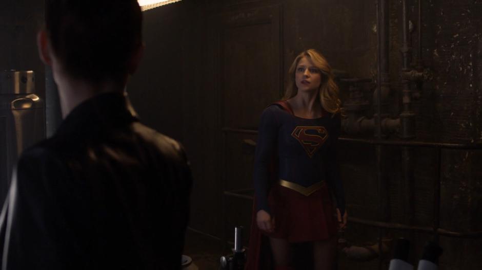 Kara enters Lex's secret lab and looks over at Lena.