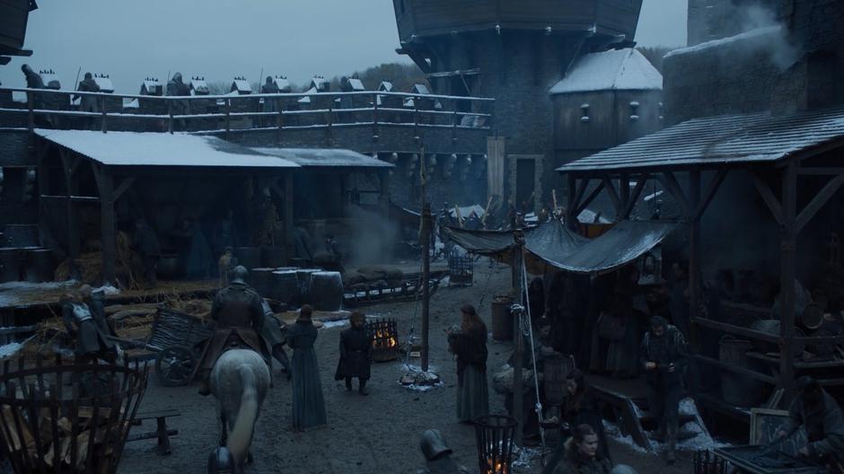 Tyrion walks through the castle yard looking for his brother.