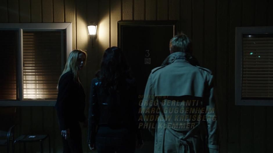 Sara glances to Nora for confirmation as they approach room three with Constantine.