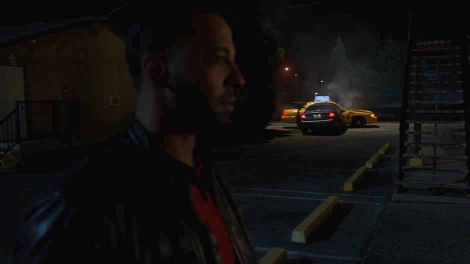 Neron walks to his room as a car crashes into a taxi in the background.