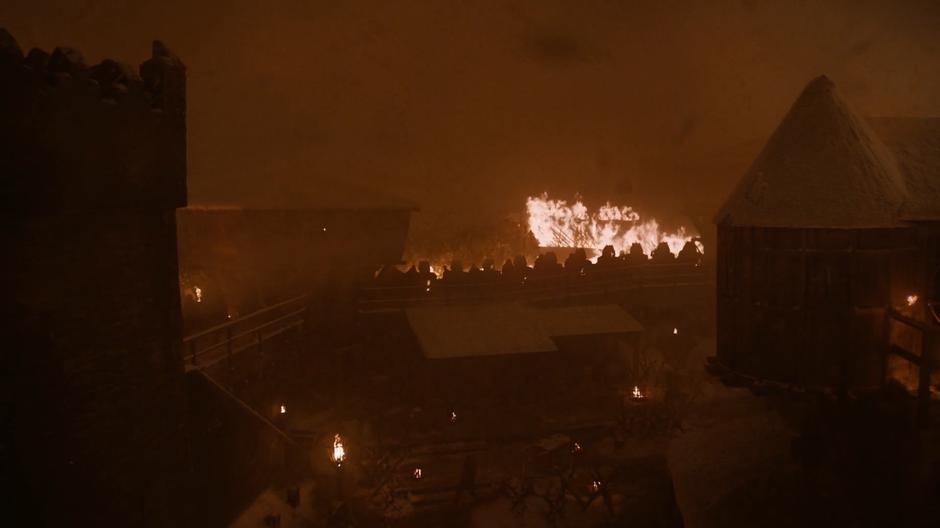 The dead storm over the fiery barricade through the smoke.