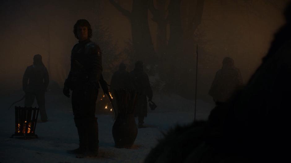 Theon looks back at Bran as the battle rages outside the woods.