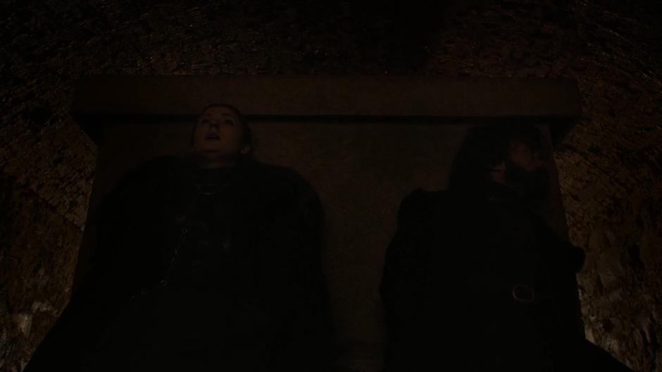Sansa and Tyrion hide behind a crypt after the dead have risen.
