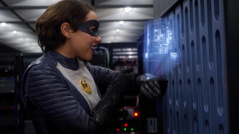 Nora smiles when the blueprints appear on her holographic display.