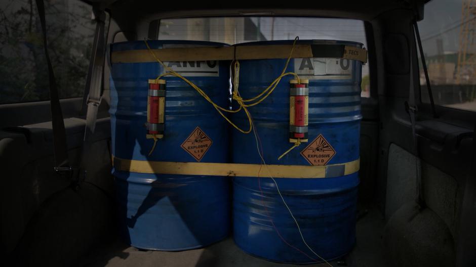 Several large barrels of explosive sit in the back of the van.