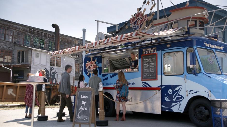 A man approaches the food truck where Dolly Durkins is working.