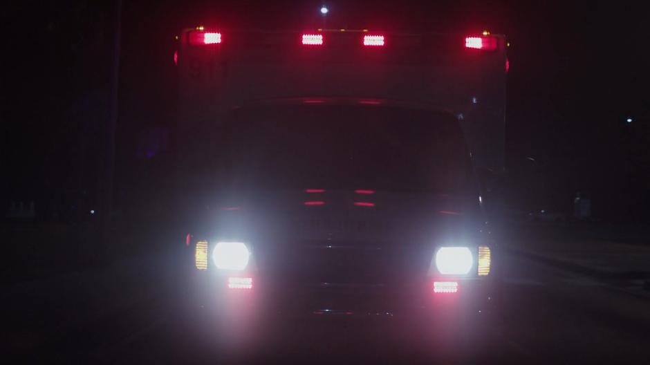 An ambulance follows close behind the stolen car.