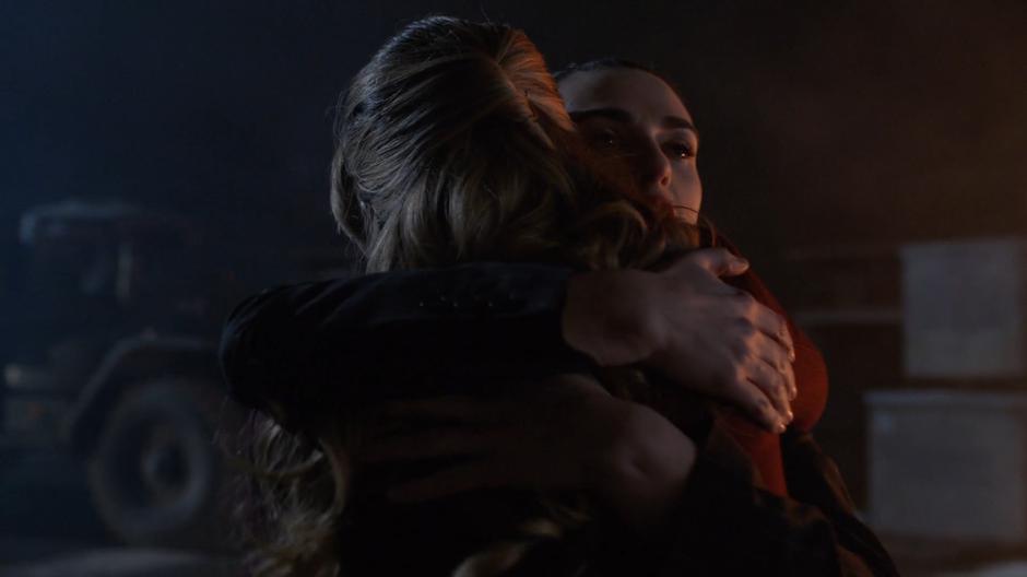 Lena desperately hugs Kara after finding her safe after the explosion.