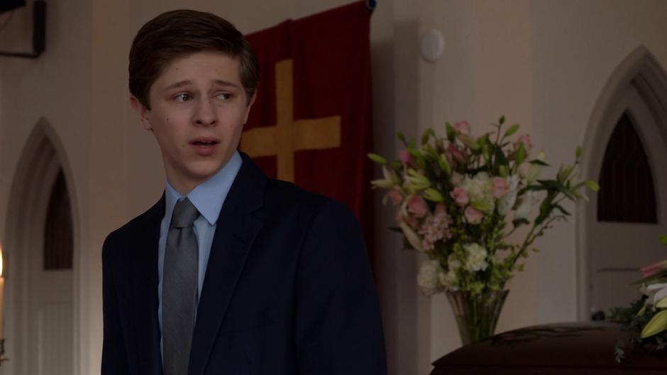 George Lockwood looks over at the picture of his mother while delivering her eulogy.