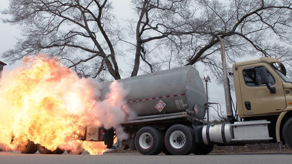 The tanker truck explodes after Ben Lockwood is thrown into it by J'onn.