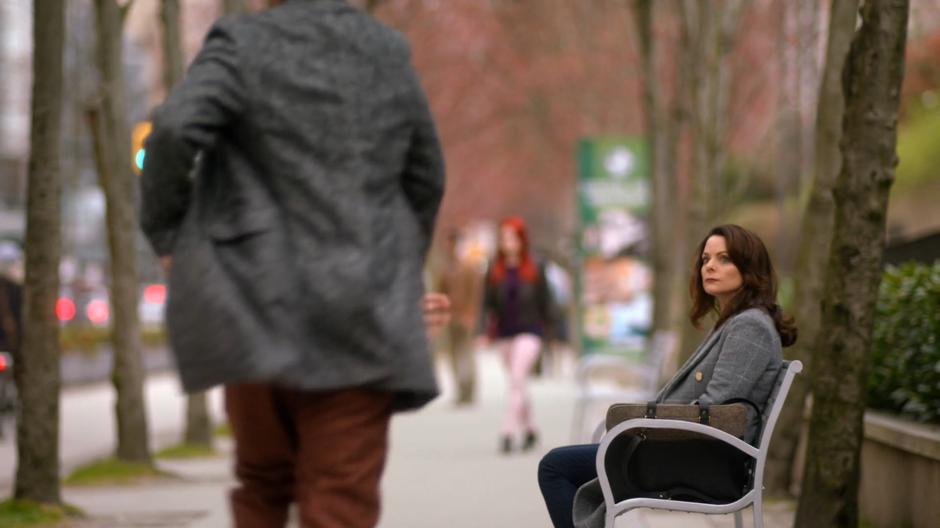 Renee looks up from the bench as Sherloque approaches her.