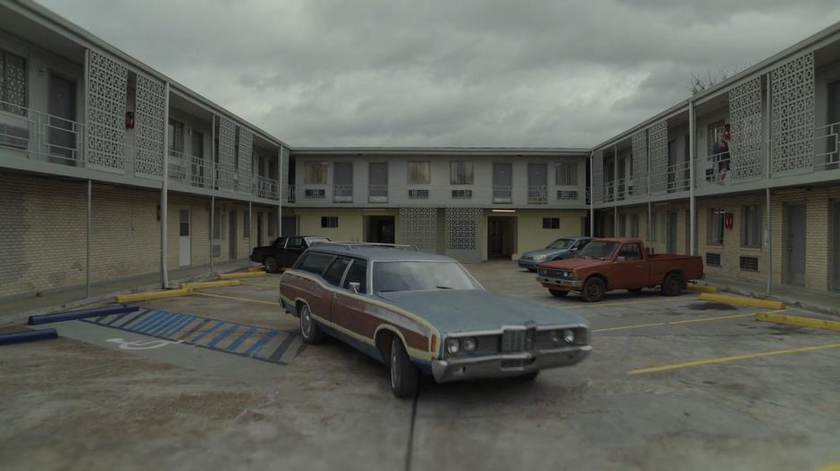 A car pulls out of the motel's parking lot.