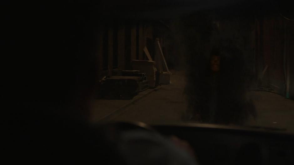 Tyrone appears in front of the ambulance as it turns into a dark alley.