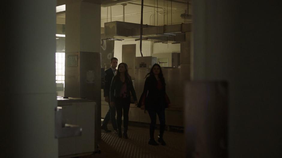 Harry, Maggie, and Mel search through the abandoned kitchen.