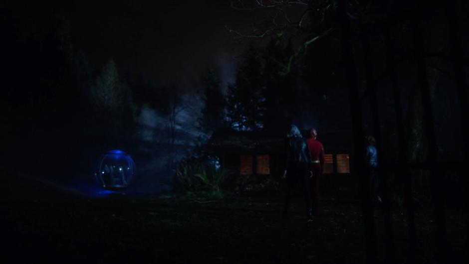 Caitlin, Barry, and Nora walk towards the cabin where the Time Sphere is parked.