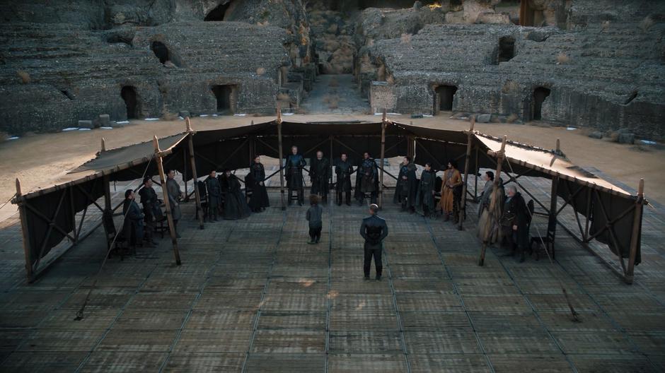 The assembled lords and ladies of the Six Kingdoms stand to welcome Bran as their new king.