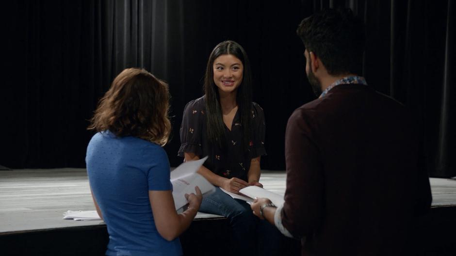 Yasmine smiles at Peyton and Ravi when they say they like her new script.