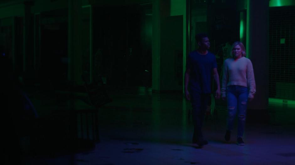 Tyrone and Tandy wander through the dark interior of the mall.