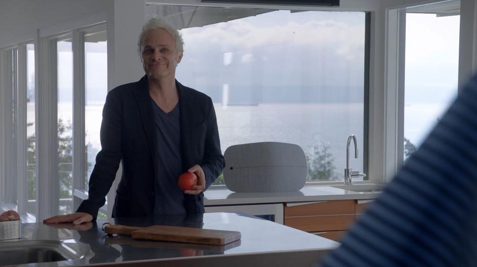 Blaine smiles at Brandt Stone while holding an apple after Stone emerges from his bedroom.