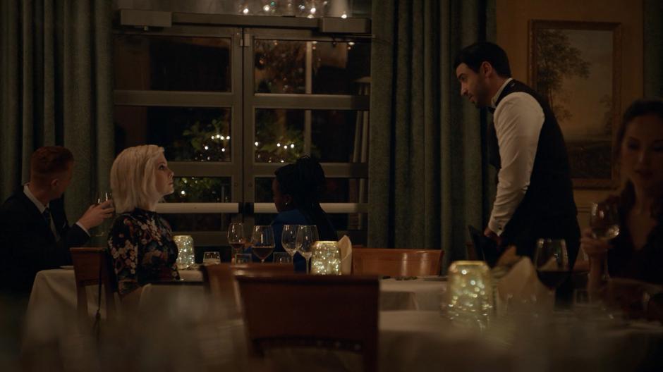 A waiter approaches Liv's table to tell her that they are out of the brain she ordered.
