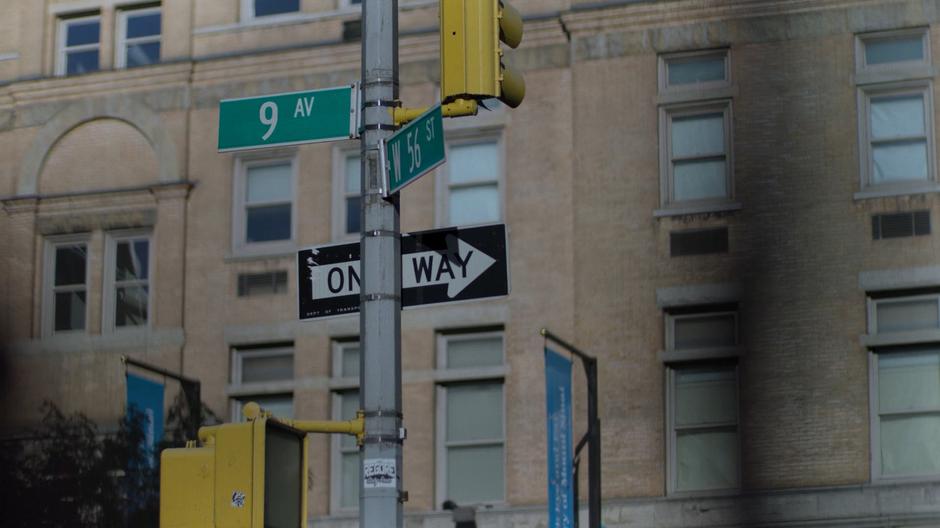 The signs for 9th Avenue & 56th Street sit at the intersection.