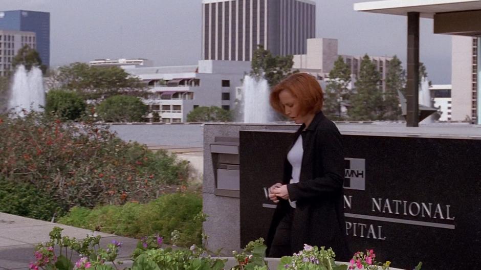 Scully takes out her keys while walking to her car.