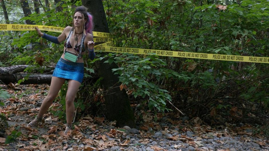 Lisa wanders under the police tape while still high after partying all night in the woods.