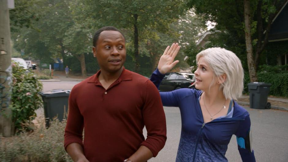 Liv puts her hand up for a high-five while walking to the house with Clive.