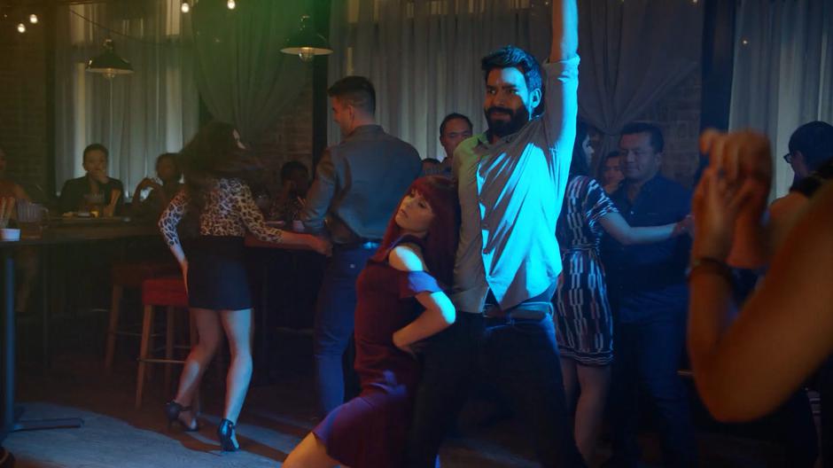 Ravi dances awkwardly while Liv dances circles around him.