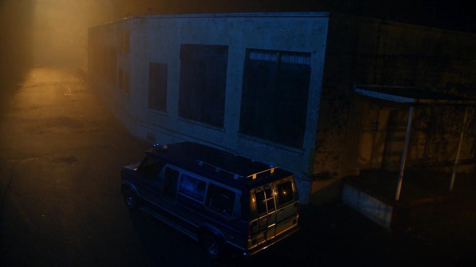 Beanpole Bob's van sits in the darkened alley near his lab.