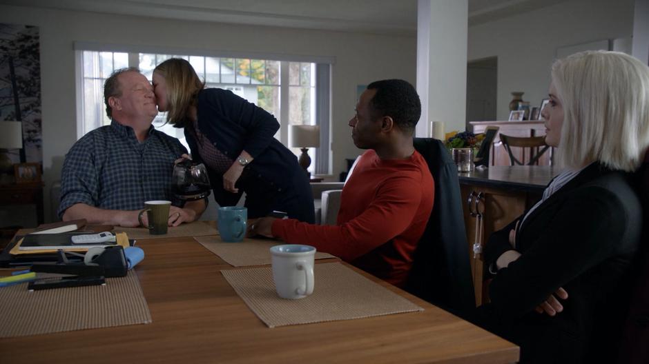 Clive and Liv watch as Margaret Klein leans down to give her husband Jack a kiss after pouring him some coffee.