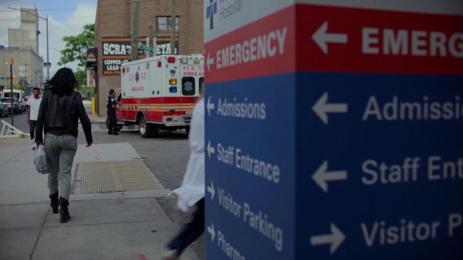 Jessica walks off down the street past the emergency room entrance.