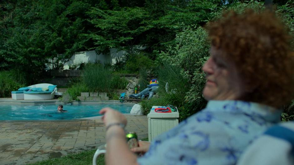 Sal Blaskowski checks her watch as Erik bursts through the water in the pool.