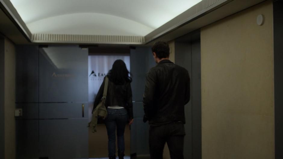 Jessica and Erik walk from the elevators to the offices.