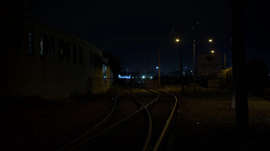 Establishing shot of the darkened rail yard.