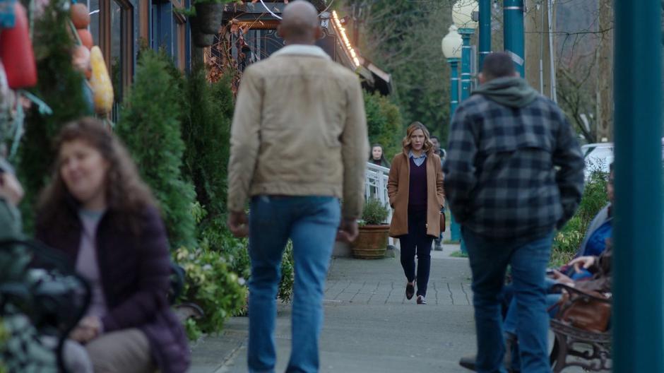 Beth Marzdan walks down the sidewalk after leaving the store as Levi and Xander walk in her direction.