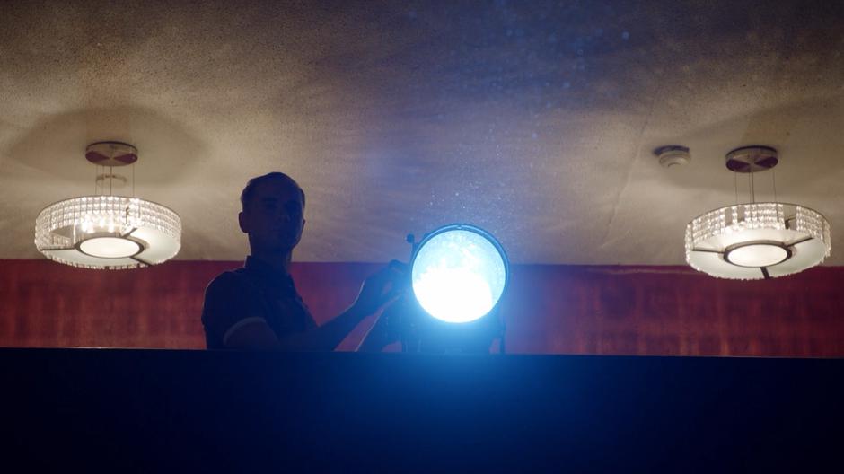 A operator adjusts the color of the spotlight during rehearsal.