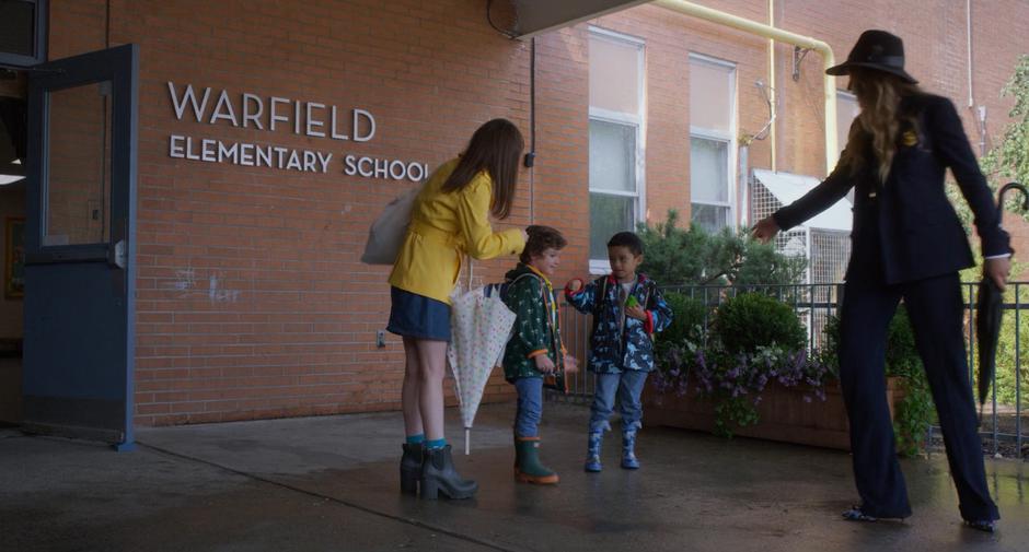 Stephanie and Emily reach for Miles and Nicky as they prepare to leave school.