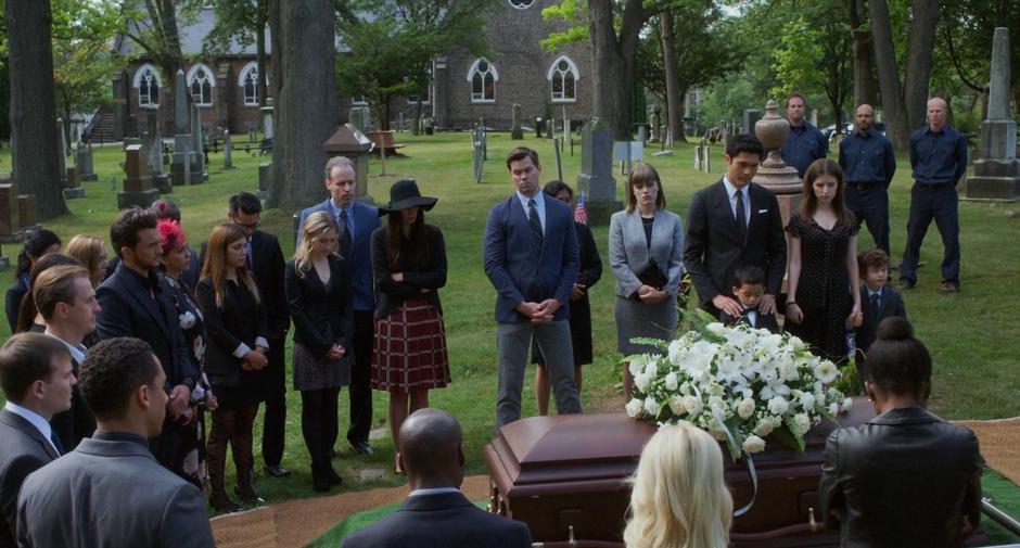 A group of mourners stand around Emily's coffin including Darren, Stacy, Sean, Nicky, Stephanie, and Miles.