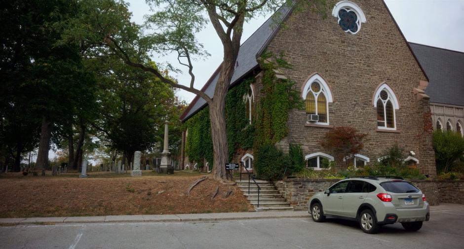 Stephanie's car sits parked in front of the church.