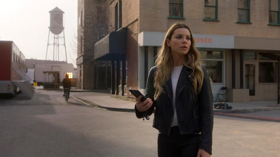 Chloe looks over as her father calls out her name while waiting outside her trailer for Lucifer.