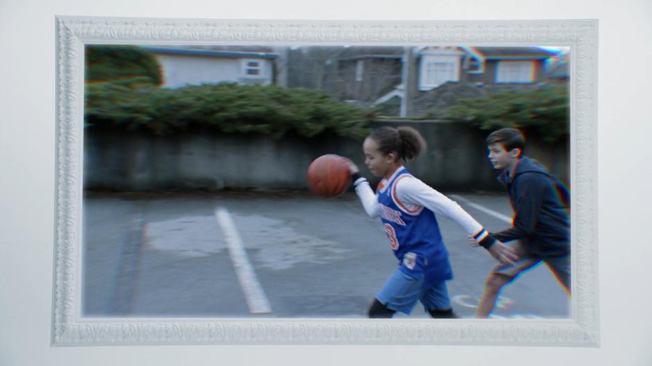 Clive and Dale's daughter and son play basketball in a home video.