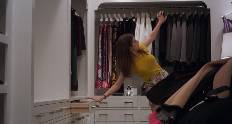 Stephanie packs up Emily's old clothing in her walk-in closet.