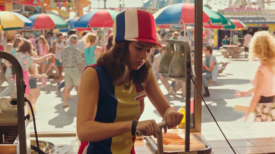 Charlie prepares some food in the Hot Dog on a Stick stand.