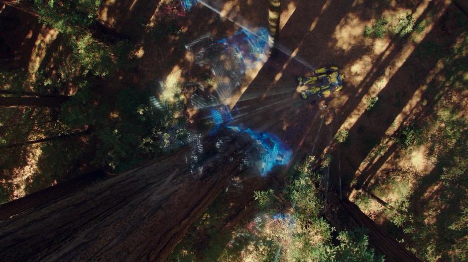 Charlie and Bumblebee look up as a hologram of Megatron is projected into the canopy.