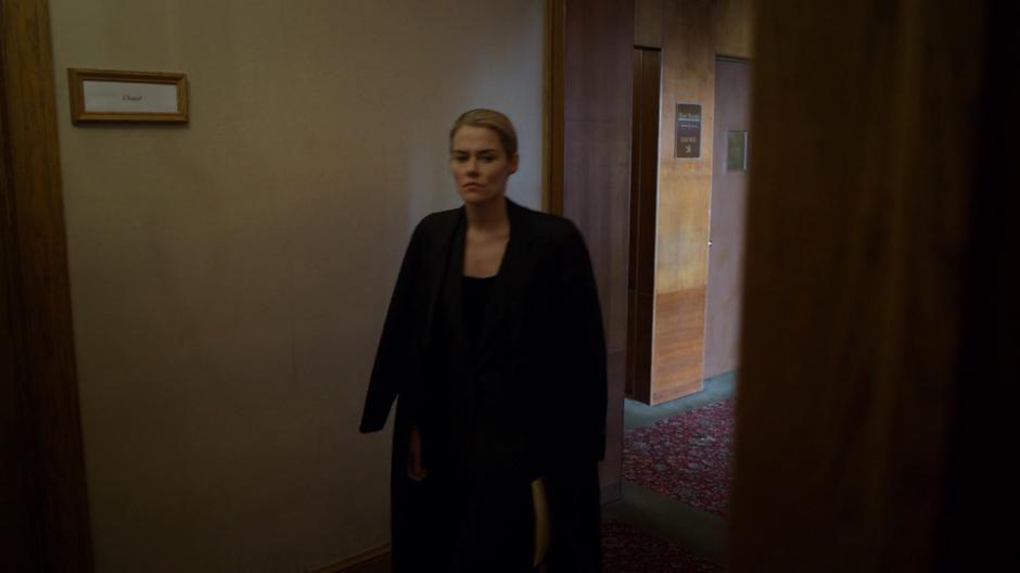 Trish walks towards the room for the funeral.