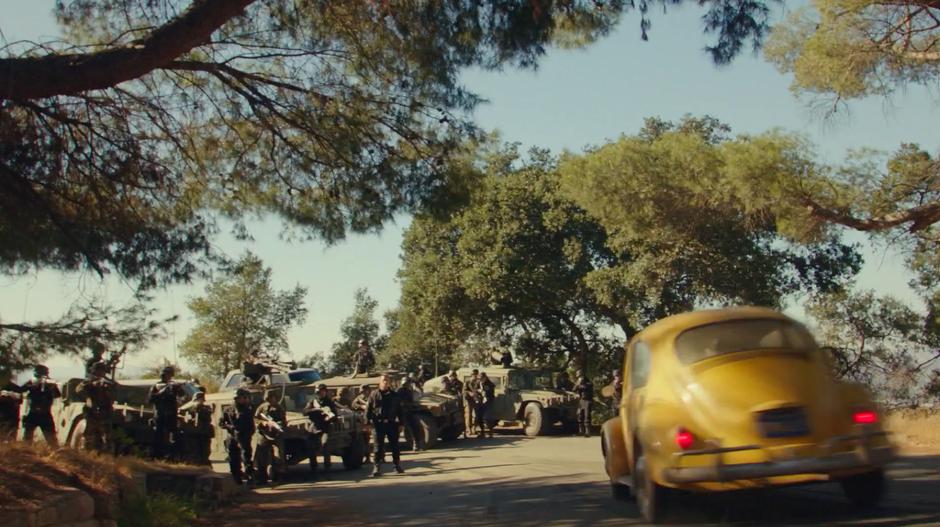 Bumblebee slows to a stop after turning the corner and finding a military roadblock with Agent Burns waiting.